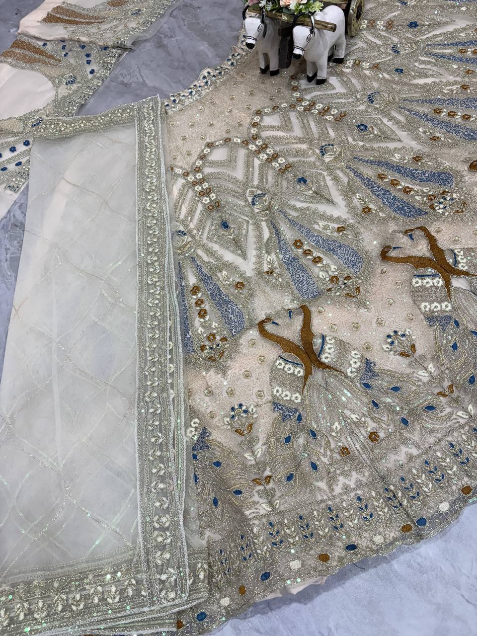 Ivory Gold Peacock Embroidered Net Lehenga Choli with Blue Accents
