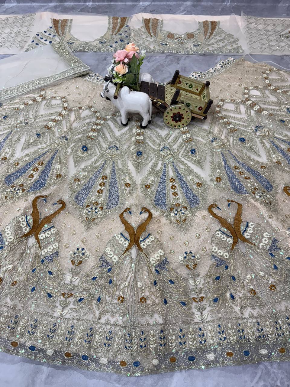 Ivory Gold Peacock Embroidered Net Lehenga Choli with Blue Accents
