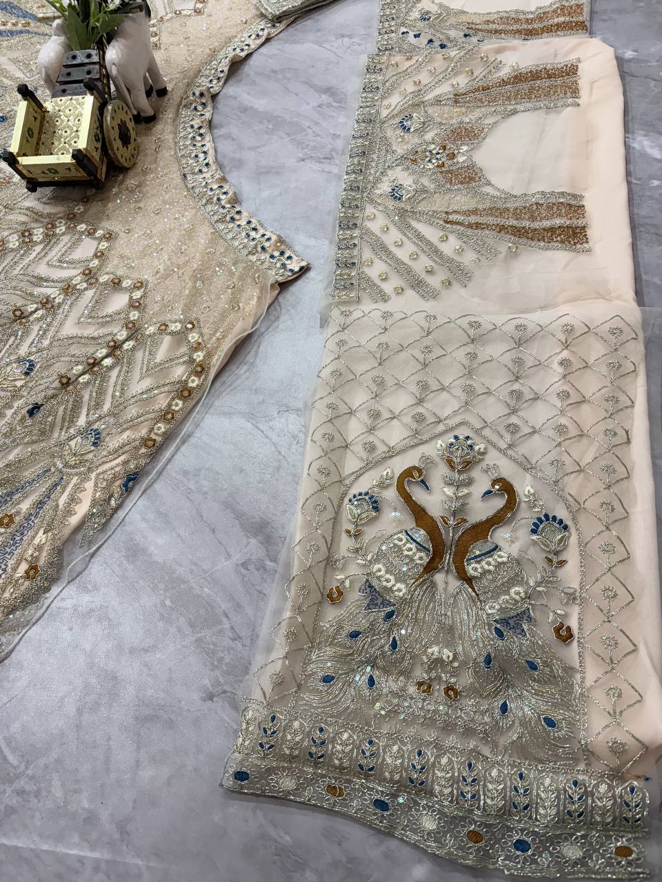 Ivory Gold Peacock Embroidered Net Lehenga Choli with Blue Accents