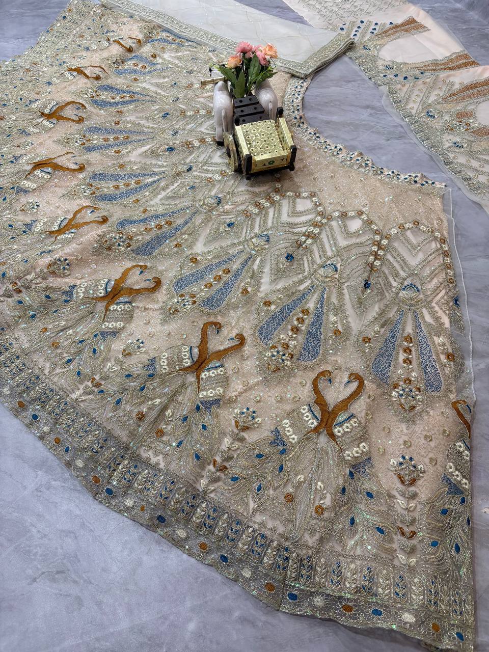 Ivory Gold Peacock Embroidered Net Lehenga Choli with Blue Accents